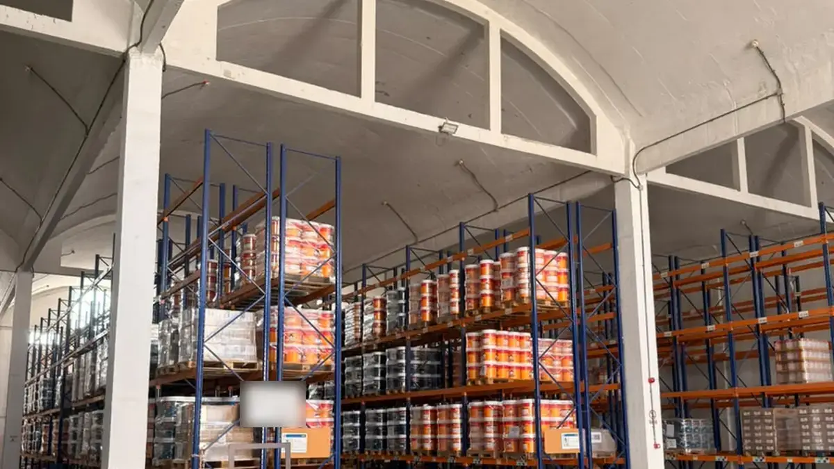 Form M godown with drums and cans of paint and chemicals stored on steel racks